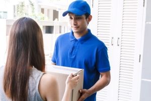 Woman accepting a delivery boxes from delivery man